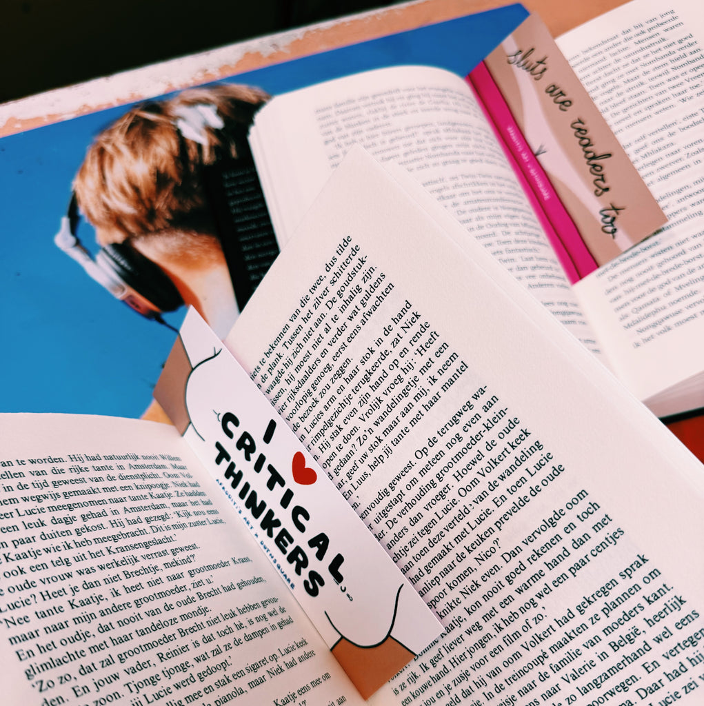 Open book with a bookmark titled 'I love critical thinkers' and another titled "sluts are readers too"
